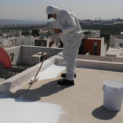worker applying elastomeric roof coating