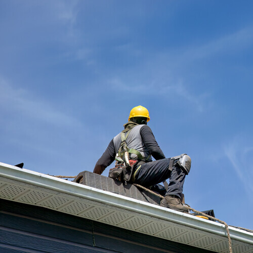 worker repairing the roof of a mobile home