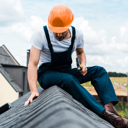 worker conducting a roof inspection