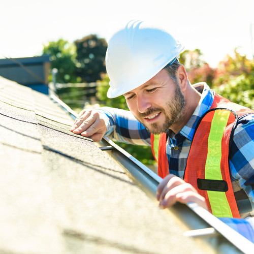 a worker inspecting a roof