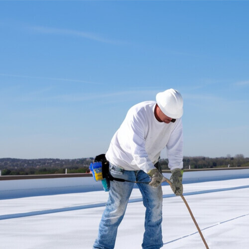 worker applying a rubber roof coating